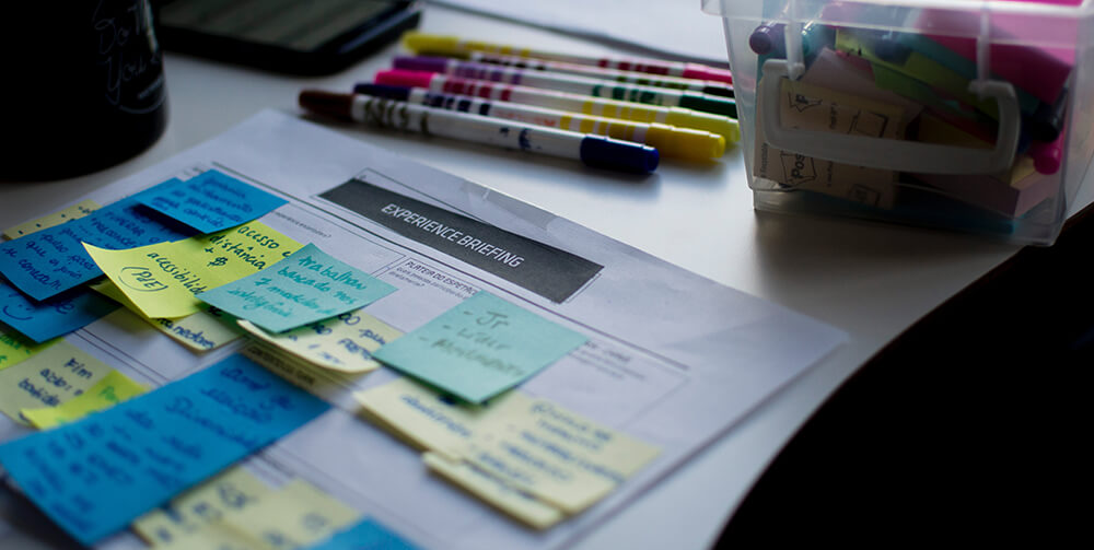 Multiple post it notes on a letter with coloured pens