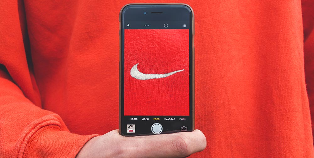 red nike tick on a mobile phone