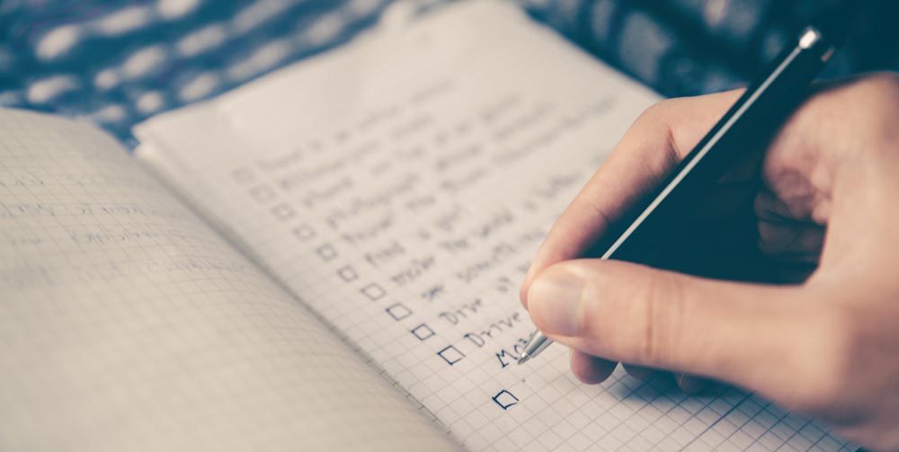 someone writing a checklist