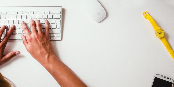 person typing on a white keyboard
