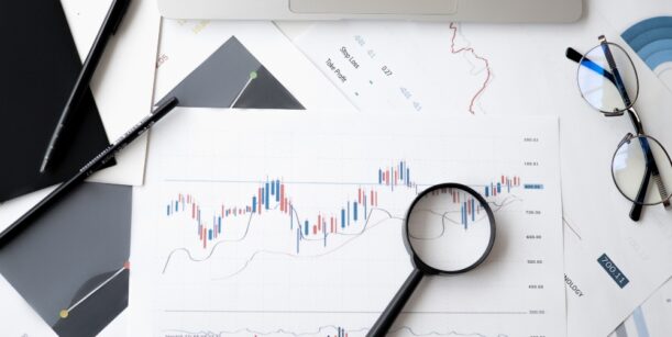 magnifying glass on graph with glasses