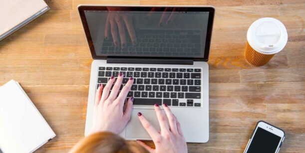 laptop and paper coffee cup