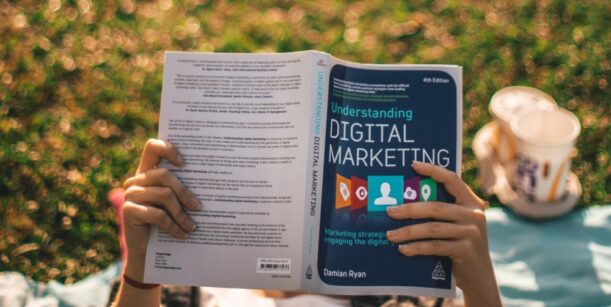 Person holding digital marketing book
