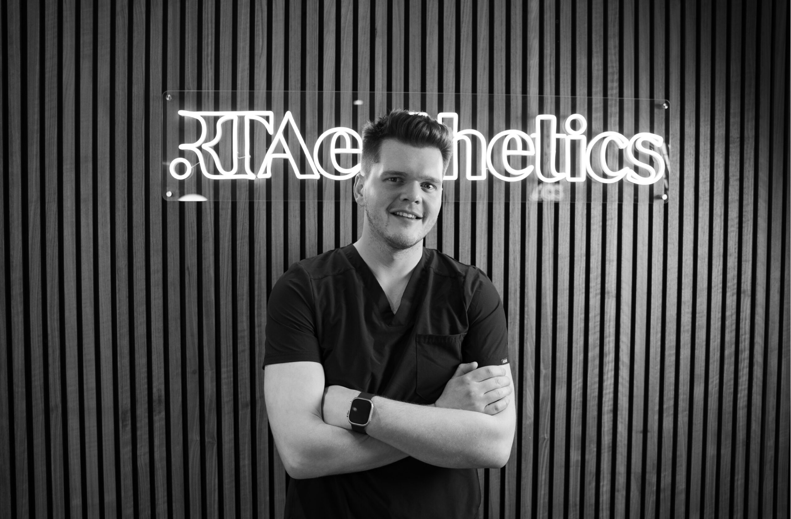 man standing in front of illuminated logo