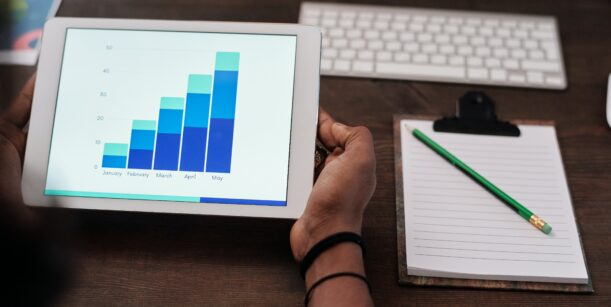 someone holding ipad with graphs on