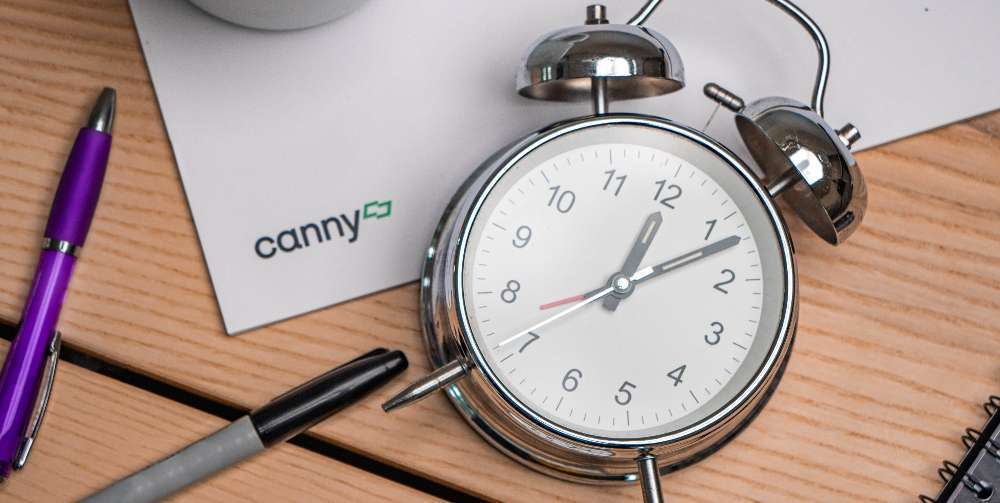 silver clock on a wooden surface