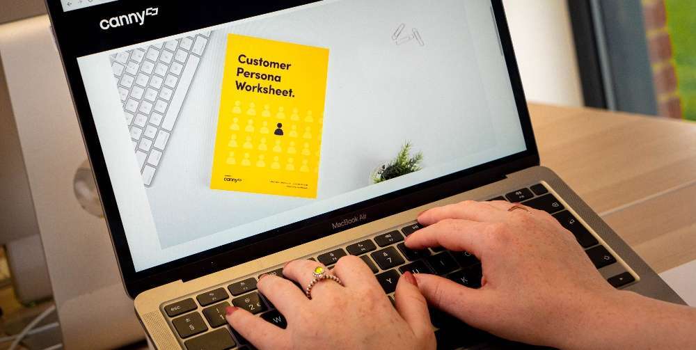 person looking at customer worksheet on laptop